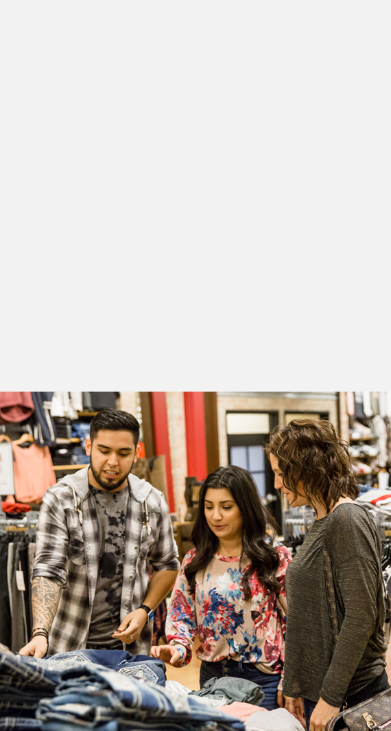 Two Buckle Guests being helped by a Buckle stylist